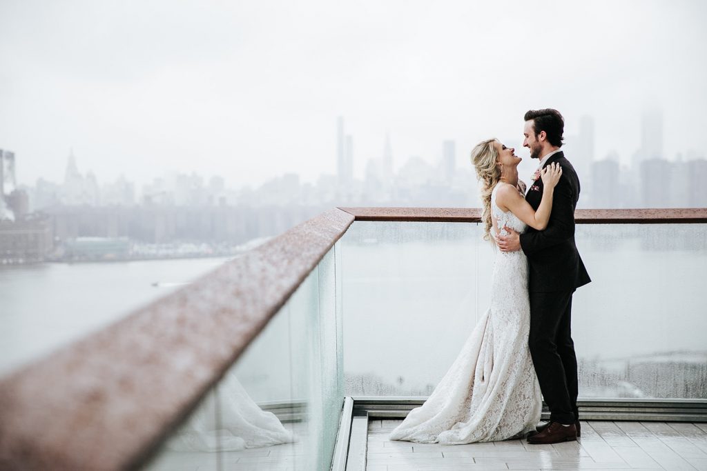 Couple elopes in private penthouse with NYC skyline in the background.