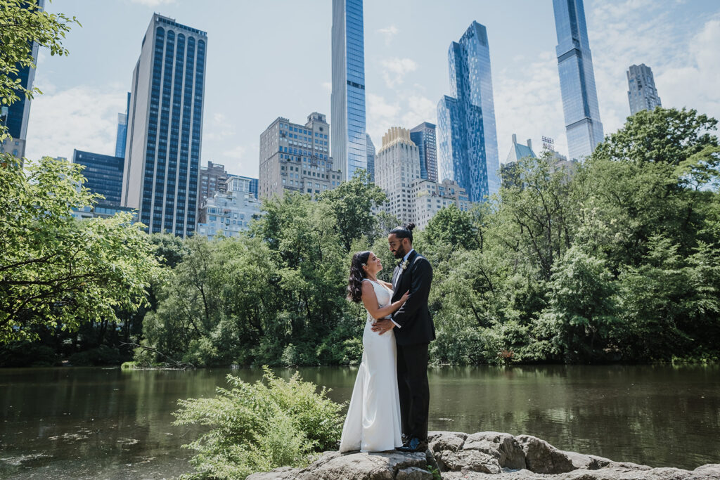 Couple stands in iconic Central Park location during NYC elopement.