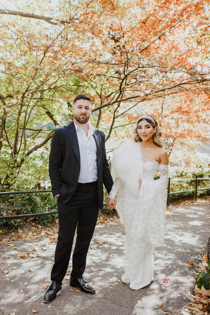 Couple elopes in Central Park during the autumn season.