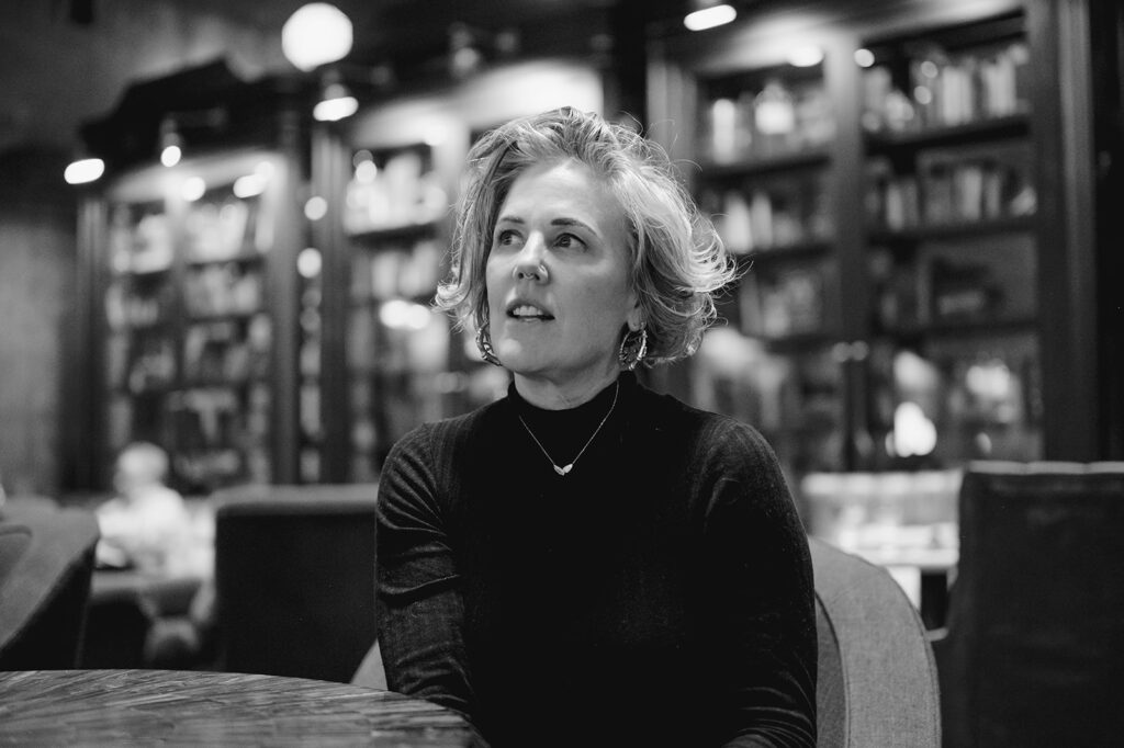 Jenny Mac looks thoughtfully into the distance.