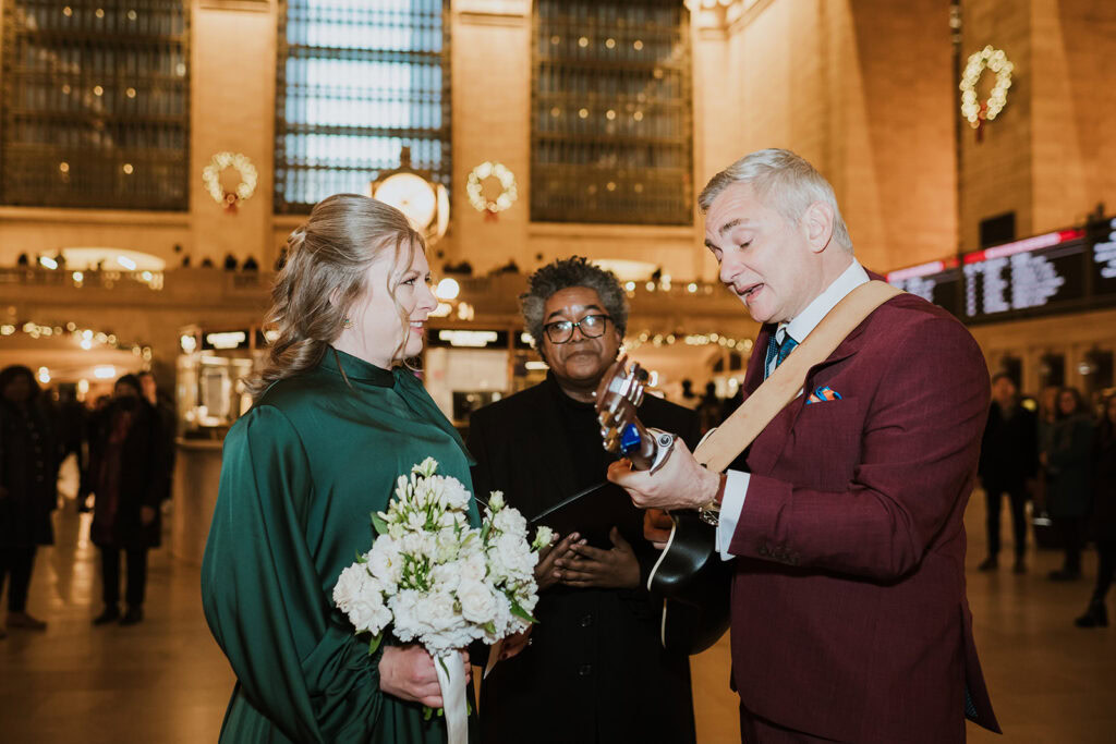 Groom sings song to his bride before saying their vows at Grand Central Terminal elopement in NYC.